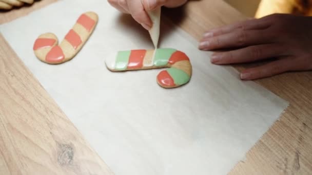 Preparing Homemade Christmas Gingerbread Candy Cane Cookies Woman Decorating Them — Stock Video