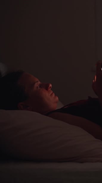 Natten Ligger Den Unga Kvinnan Sängen Mittemot Fönstret Och Leker — Stockvideo