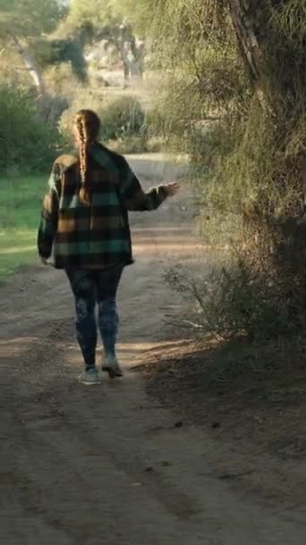 Young Woman Plaid Shirt Walks Forest Touches Plant Tree Vertical — Stock Video