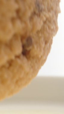 Kurabiyeleri çikolatalı süte batırıyorum. Dolly sürgülü yakın çekim. Dikey video Sosyal Ortamı