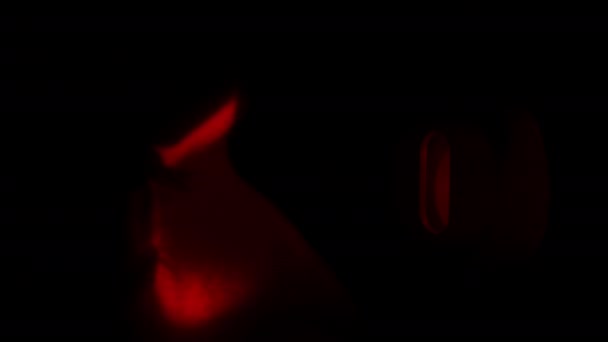 Man Watching Someone Peeps Keyhole Red Light Shines Close Eye — Stock Video