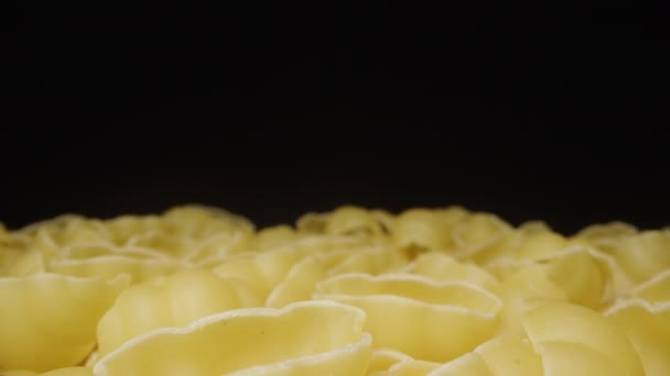 Dry Pasta Rotates Scattered Evenly Table Black Background Close Dolly — Stock Video
