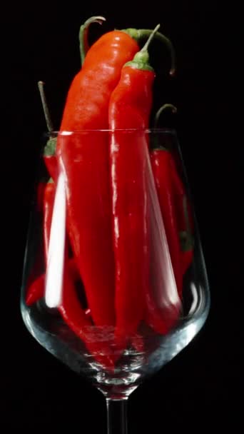 Red Chili Peppers Wine Glass Rotation Black Background Concept Vertical — Stock Video