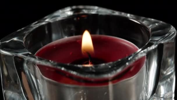 Red Candle Burns Close Rotates Glass Candlestick Black Background — Stock Video