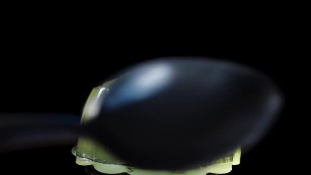 Green Jelly Close Black Background Swing Spoon Hit Sways Slow — Stock Video