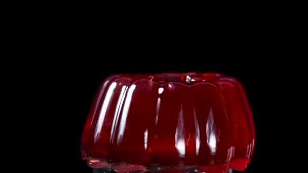 Red Jelly Rotates Close Black Background Hit Spoon Droplets Fly — Stock Video