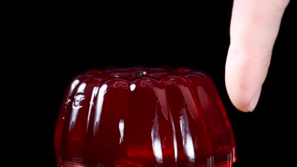 Red Jelly Close Black Background Rub Finger Sways Slow Motion — Stock Video