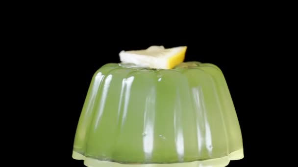 Green Jelly Rotates Black Background Lemon Slices Served Top Close — Stock Video