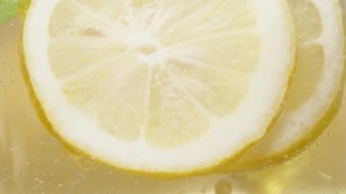 Limonata ve buzu karıştırıyorum, limon ve nane karışımı, yavaş, makro.