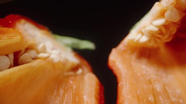 スーパーマクロ カメラは赤唐辛子を半分に切ったスライド 黒い背景に — ストック動画