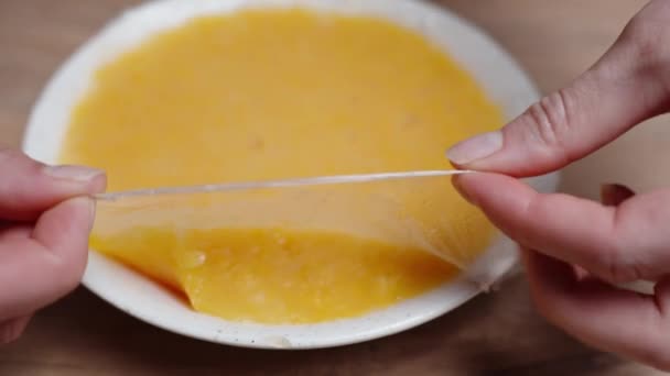 Pastry Chef Removing Plastic Wrap Plate Orange Compote — Stock Video