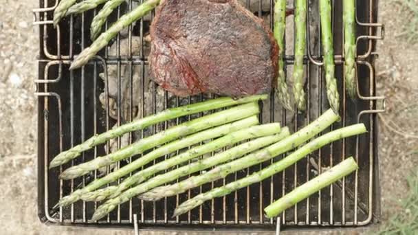 Pemandangan Atas Panggangan Portabel Dengan Steak Dan Asparagus Yang Dimasak — Stok Video