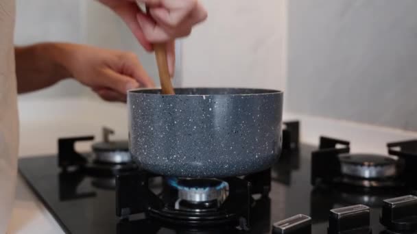 Saucepan Placed Gas Stove Woman Stirring Something Wooden Spoon Close — Stock Video