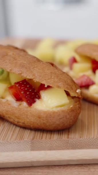 Eclair Pastries Strawberry Filling Garnished Mint Presented Wooden Table Close — Stock Video