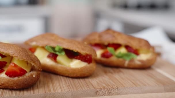 Close Overview Homemade Eclairs Filled Strawberry Mango Filling Topped Mint — Stock Video