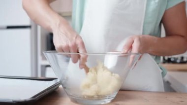 Aşçı hamur kremasını tahta kaşıkla karıştırıyor..