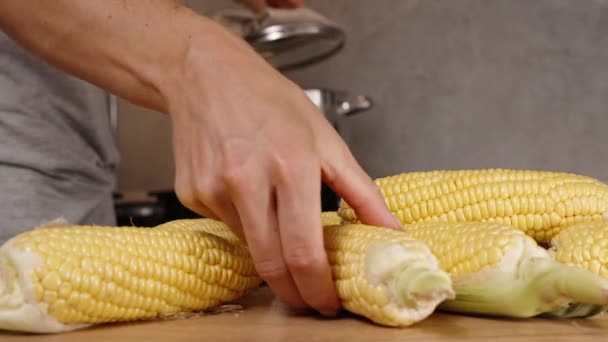 Foreground Corn Placed Table Woman Adds Them Pot Boiling Water — Stock Video