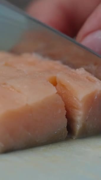 Vertical Video Woman Cuts Salmon Steak Cubes Close — Stock Video