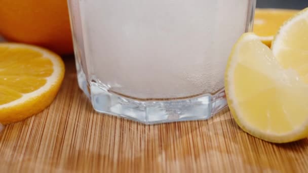 Slow Motion Lemon Orange Slices Wooden Table Soda Poured Glass — Stock Video