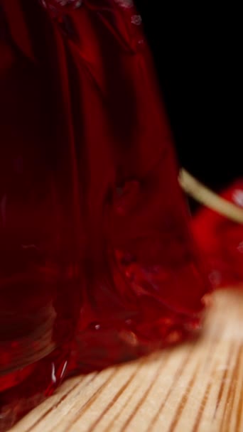 垂直录像 红色的自制果冻和樱桃浆果散落在一张木制桌子上 多利滑翔机极端特写 — 图库视频影像