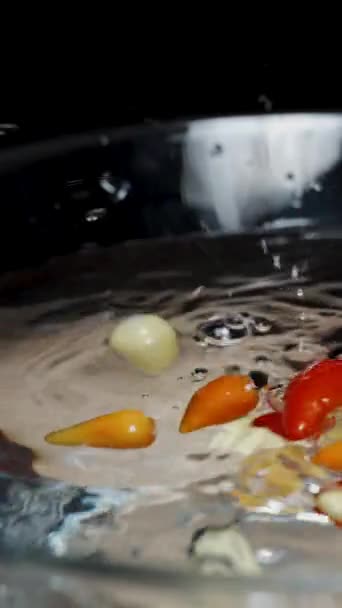 Vertical Video Multicolored Mini Chili Peppers Fall Glass Bowl Water — Stock Video