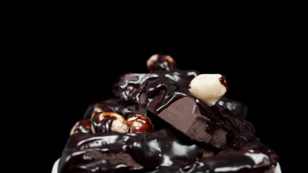 Stack Chocolate Bars Covered Dark Chocolate Sprinkled Nuts Rotating Black — Stock Video
