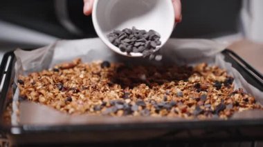 Fırından yeni çıkmış taze ev yapımı granola, üstüne çikolata dökülmüş. Yavaş çekim.