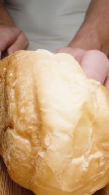 Masadaki sosislinin malzemeleri, ve kadın ekmeği ikiye bölüyor. Dolly Slider aşırı yakın çekim. Dikey video.