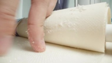 Bir adam eski bir su tabakası filtresini kesmiş ve tamamen sert su nedeniyle beyaz skalayla kaplanmış. Makro görünüm.