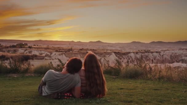 Young Couple Lies Meadow High Mountains Enjoys Sunset Woman Capturing — Stock Video