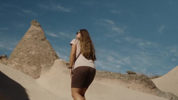 Young Woman Strolls Ancient Sandy Hills Seen Clear Blue Sky — Stock Video