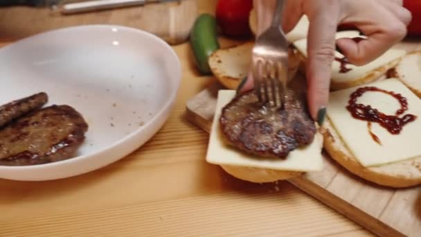 Woman Places Beef Patties Burgers Bun Cheese Red Sauce Already — Stock video