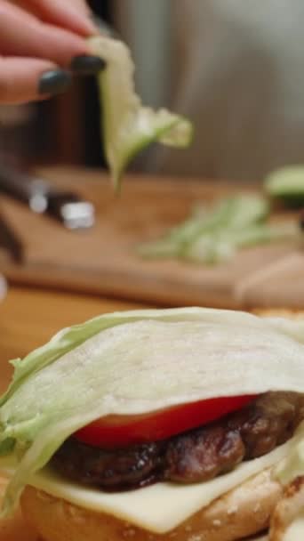 Vertical Video Burgers Homey Setting Woman Places Cucumber Slices Top — Stock Video