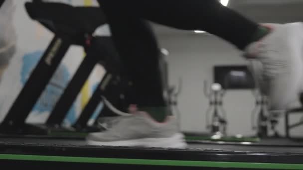 Γυναικεία Πόδια Κοντινό Πλάνο Διάδρομο Γυμναστικής Λευκά Sneakers Και Μαύρο — Αρχείο Βίντεο