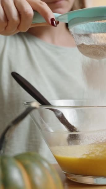 垂直录像 女人在做南瓜饼干 她用南瓜泥把面粉筛入碗里 慢动作 — 图库视频影像