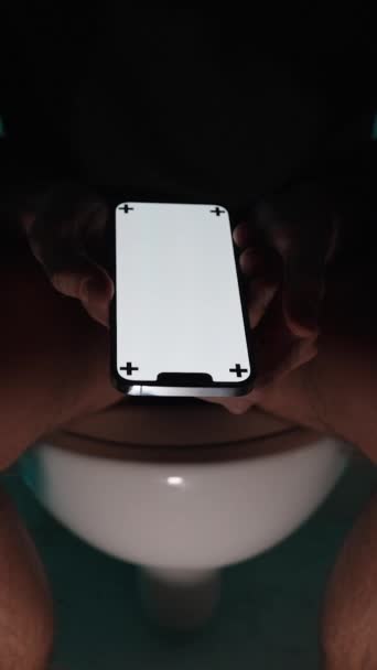 Vertical Video Darkness Man Sits Toilet Shows Smartphone Close Layout — Stock Video