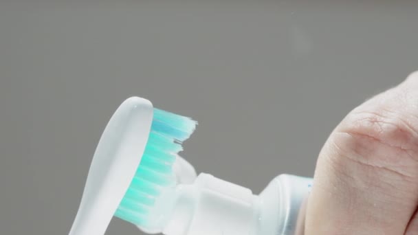 Squeezing Toothpaste Toothbrush Showing Close Blue Bristles Stock Footage