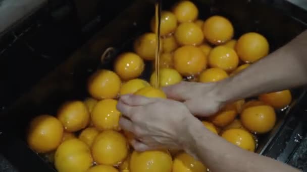 Een Hele Zwarte Gootsteen Gevuld Met Water Sinaasappels Wordt Gewassen — Stockvideo