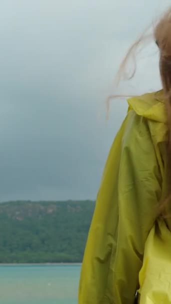 Sarı Yağmurluklu Genç Bir Kadının Arkadan Görünüşü Saçları Denizdeki Fırtına — Stok video