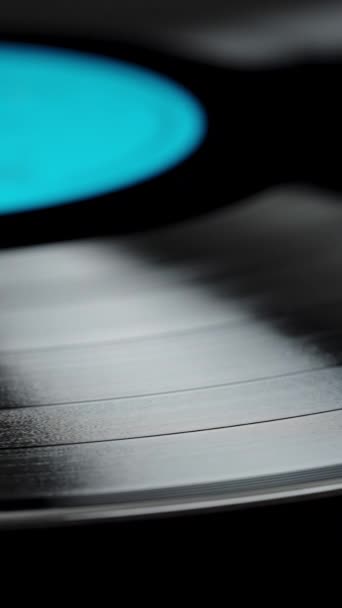 Close Vinyl Record Blue Label Slowly Rotating Black Background — Stock Video