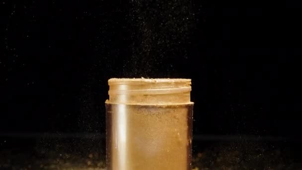 Particles Golden Dust Scatter Black Background Jar Slow Motion — Stock Video