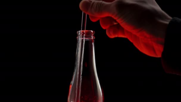Man Inserts Straw Bottle Red Light Darkness Drinks Soda Close — Stock Video