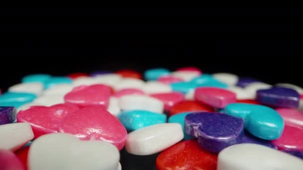 Corazones Multicolores Sobre Fondo Negro Una Superficie Cubierta Dragados Azucarados — Vídeo de stock