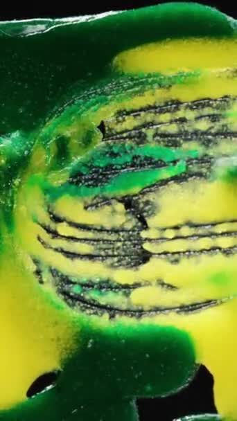 バーティカルビデオ グラスに混ぜた緑と黄砂糖のアイシング クローズアップ — ストック動画