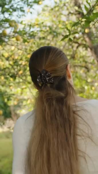 Νεαρή Γυναίκα Περπατά Ανάμεσα Λεμονόδεντρα Μαζεύοντας Ρούχα Κλαδιά Προβολή Από — Αρχείο Βίντεο