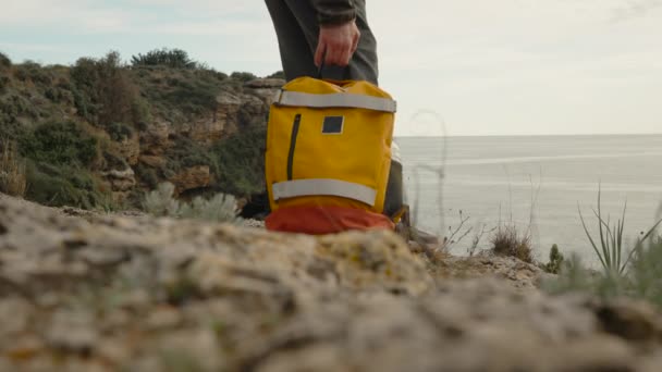 Men Legs Hiking Boots Edge Cliff Sea Putting Backpack Walking — Vídeo de Stock