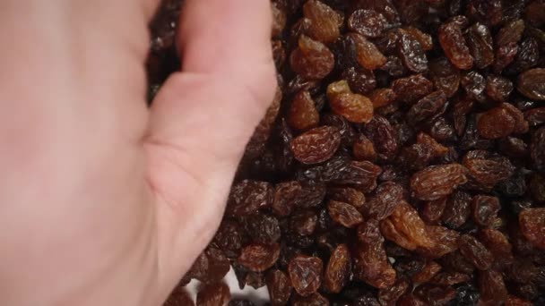Man Hand Scoops Handful Raisins Top View Close — Stock Video