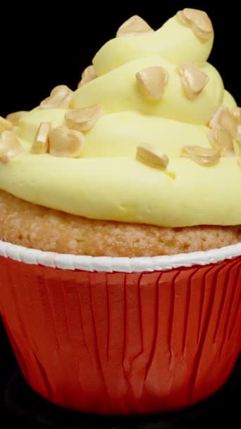 Een Cupcake Met Gele Glazuur Gouden Suikerhartjes Erop Looped Rotatie — Stockvideo
