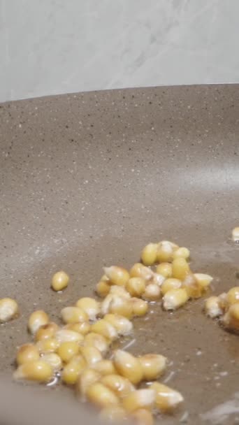 Vertical Video Stirring Corn Kernels Skillet Spatula Popcorn Preparation — Stock Video