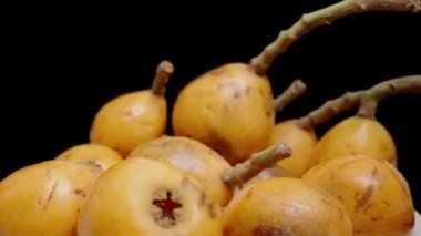 Loquat Fruits With Loquat Fruits With A Bowl, Slow Motion on Black Pground.